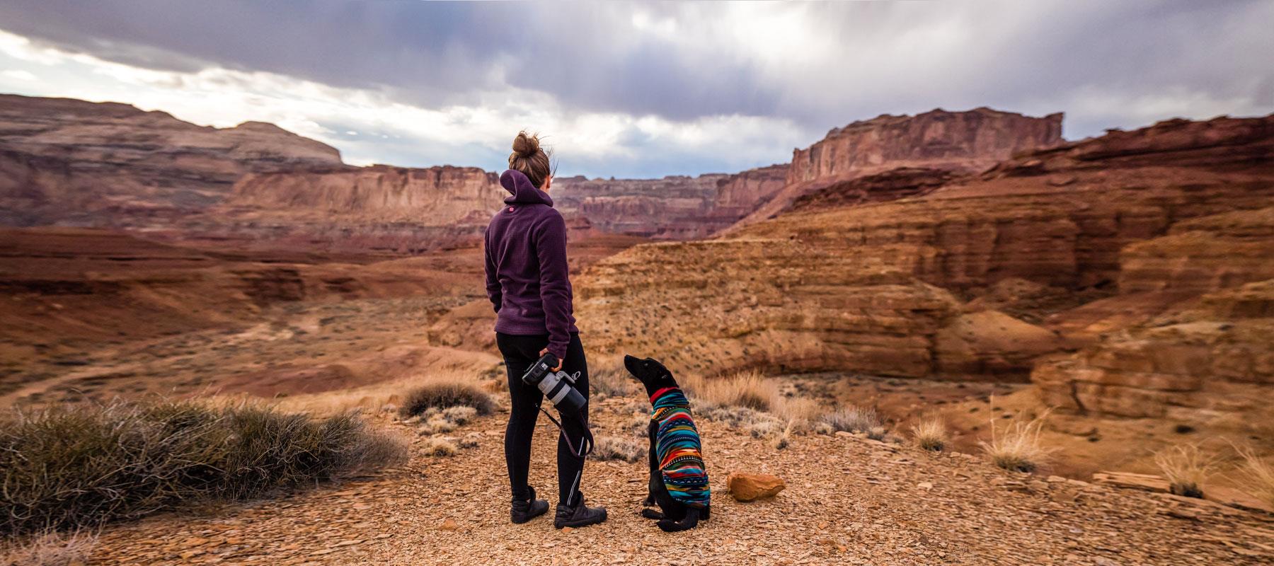 woman photographer hiking with dog san rafael swell utah